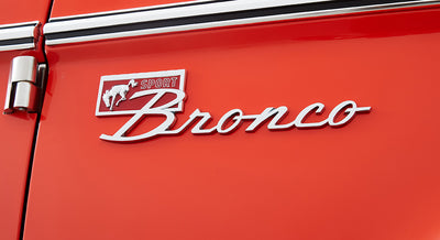 Brown textured carpet and silver foot pedals inside Classic Ford Bronco cabin