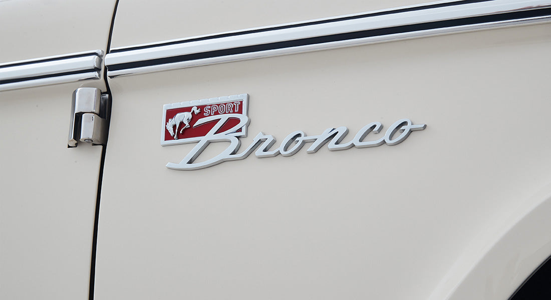 Classic Ford Bronco emblem with 'Sport' and horse logo on white vehicle side
