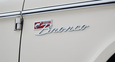 Classic Ford Bronco emblem with 'Sport' and horse logo on white vehicle side