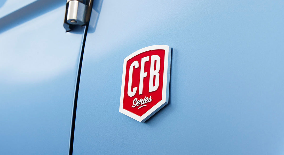 Red and white CFB Series emblem on blue vehicle door