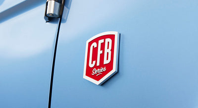 Red and white CFB Series emblem on blue vehicle door