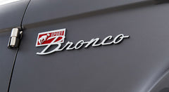 Close-up of Classic Ford Bronco Sport emblem with running horse and red detail