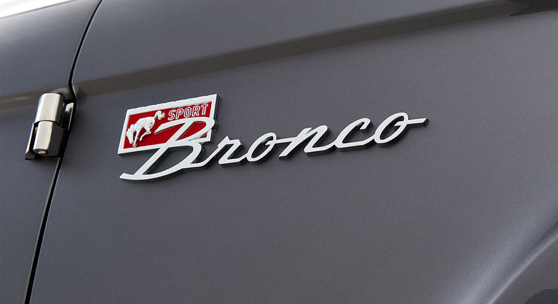 Close-up of Classic Ford Bronco Sport emblem with running horse and red detail