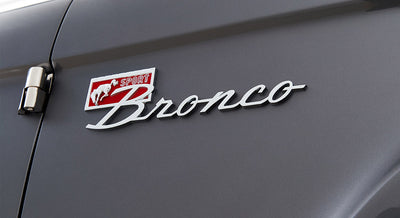 Close-up of Classic Ford Bronco Sport emblem with running horse and red detail