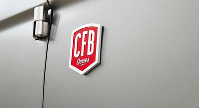 Red and white CFB Series emblem on light gray vehicle door