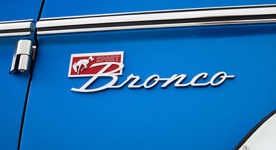 Blue exterior with Sport Bronco emblem and door hinge detail on Classic Ford Bronco