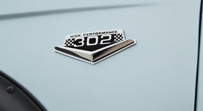 Emblem on Classic Ford Bronco showing High Performance 302 badge with checkered flag design