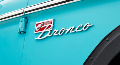 Aqua blue vehicle side panel with silver and red Sport Bronco emblem on door