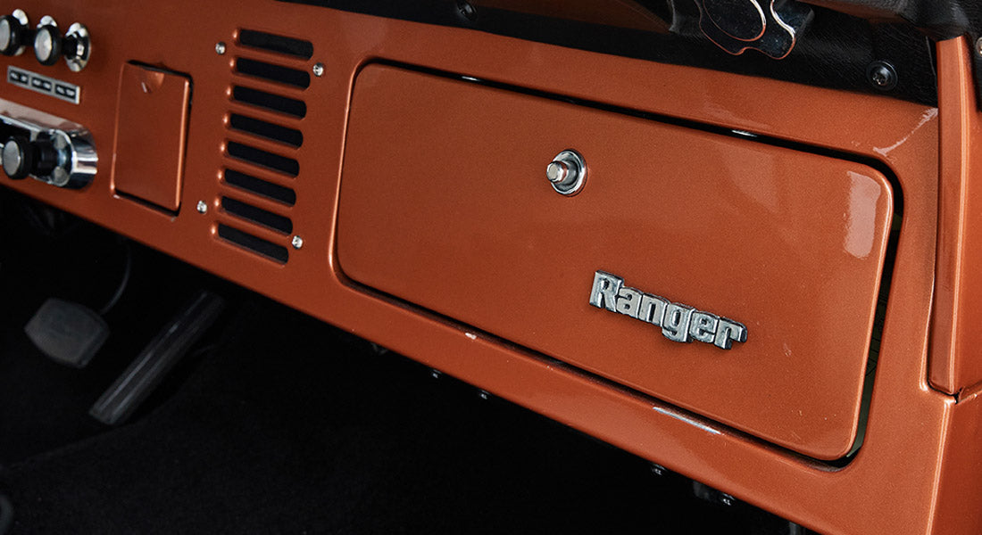 Orange interior dash panel with metal Ranger emblem on glove box door