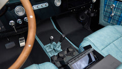 Interior floor and seats with wooden steering wheel and controls of Classic Ford Bronco