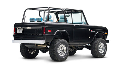 Rear three-quarter view of black Classic Ford Bronco showing exhaust and details