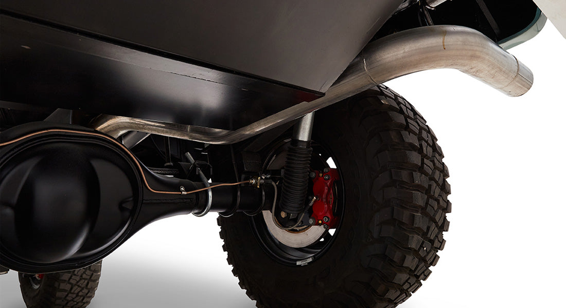 Underside view of Classic Ford Bronco showing exhaust pipe, rear axle, and tire