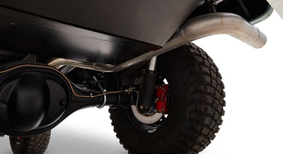 Underside view of Classic Ford Bronco showing exhaust pipe, rear axle, and tire