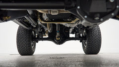 Underside view showing suspension and differential of Classic Ford Bronco with off-road tires