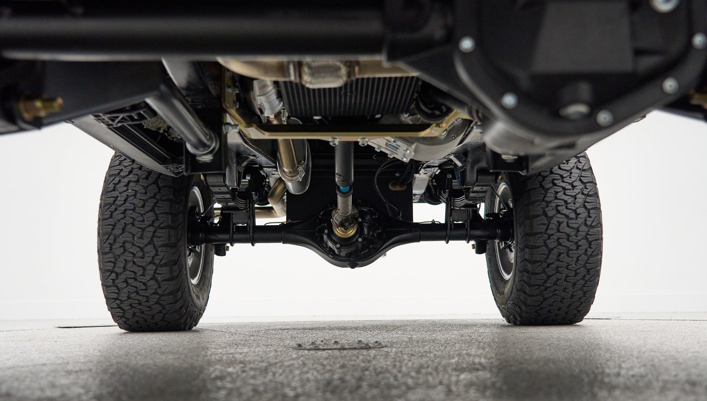 Underside view showing suspension and differential of Classic Ford Bronco with off-road tires