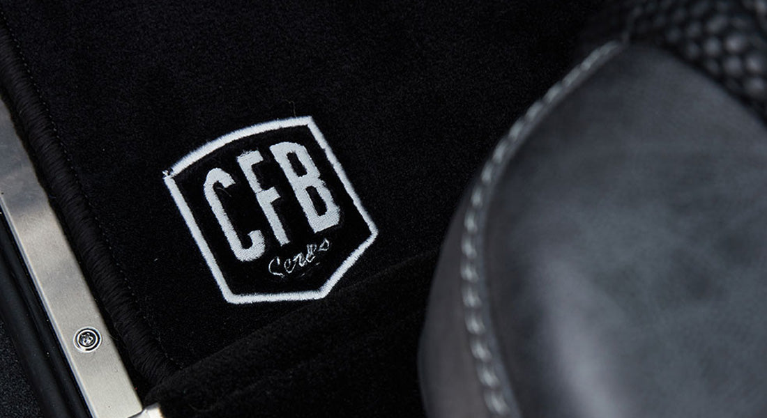Black floor mat with CFB Series logo partially under Classic Ford Bronco seat