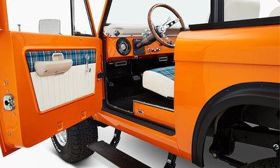 1970 Orange Classic Ford Broncos Coyote Series with white and plaid custom interior and family roll cage
