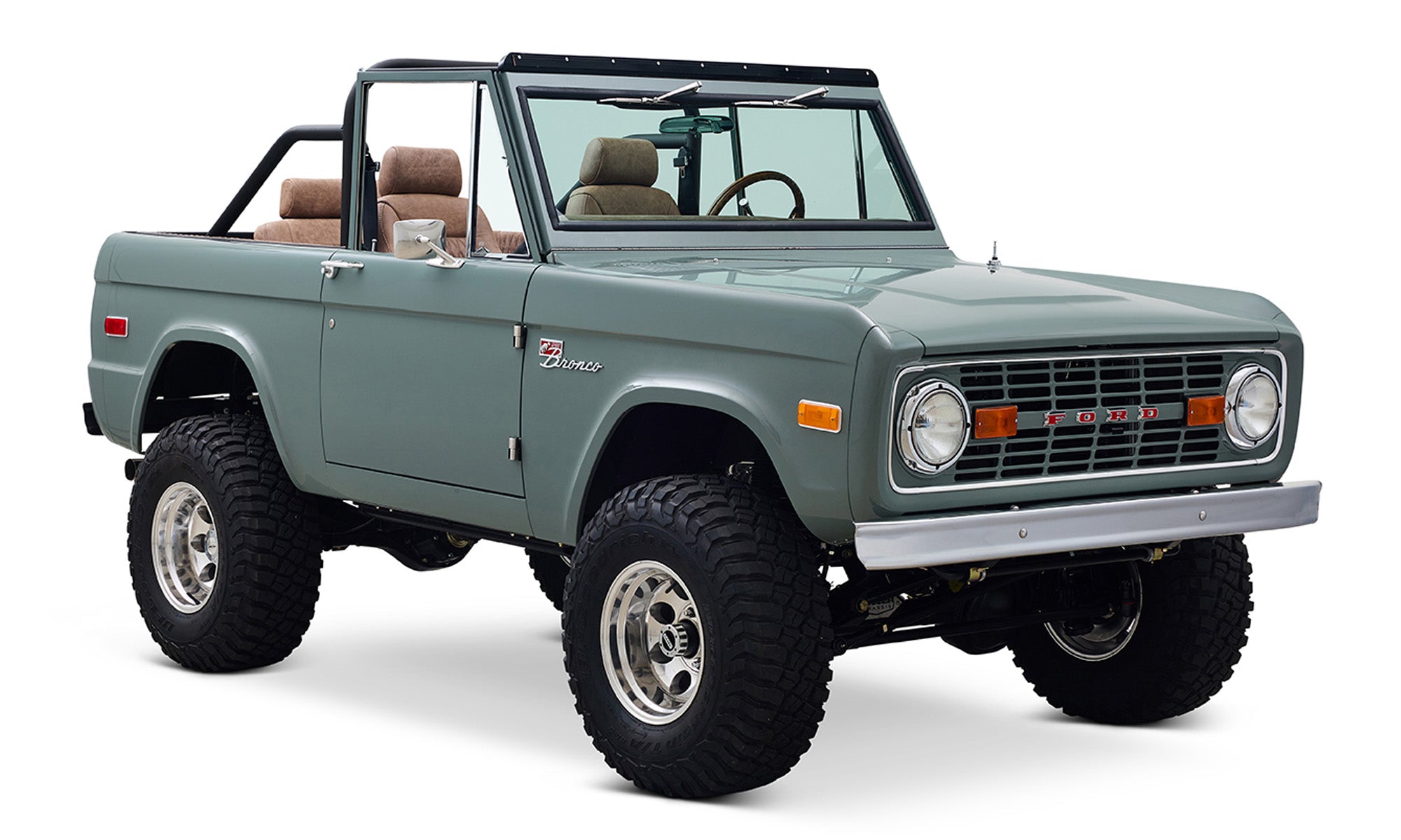 Classic Ford Bronco in marble gray seen from passenger front angled view with black roll cage