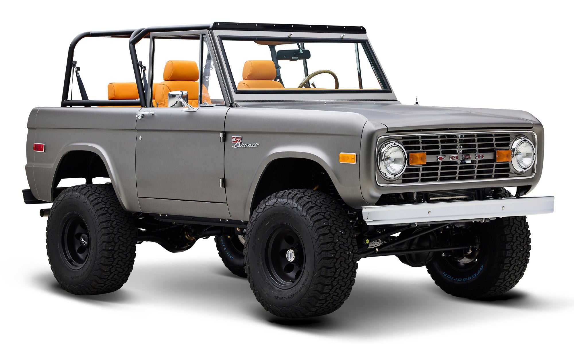 Classic Ford Bronco in matte silver side view with raised suspension and black wheels