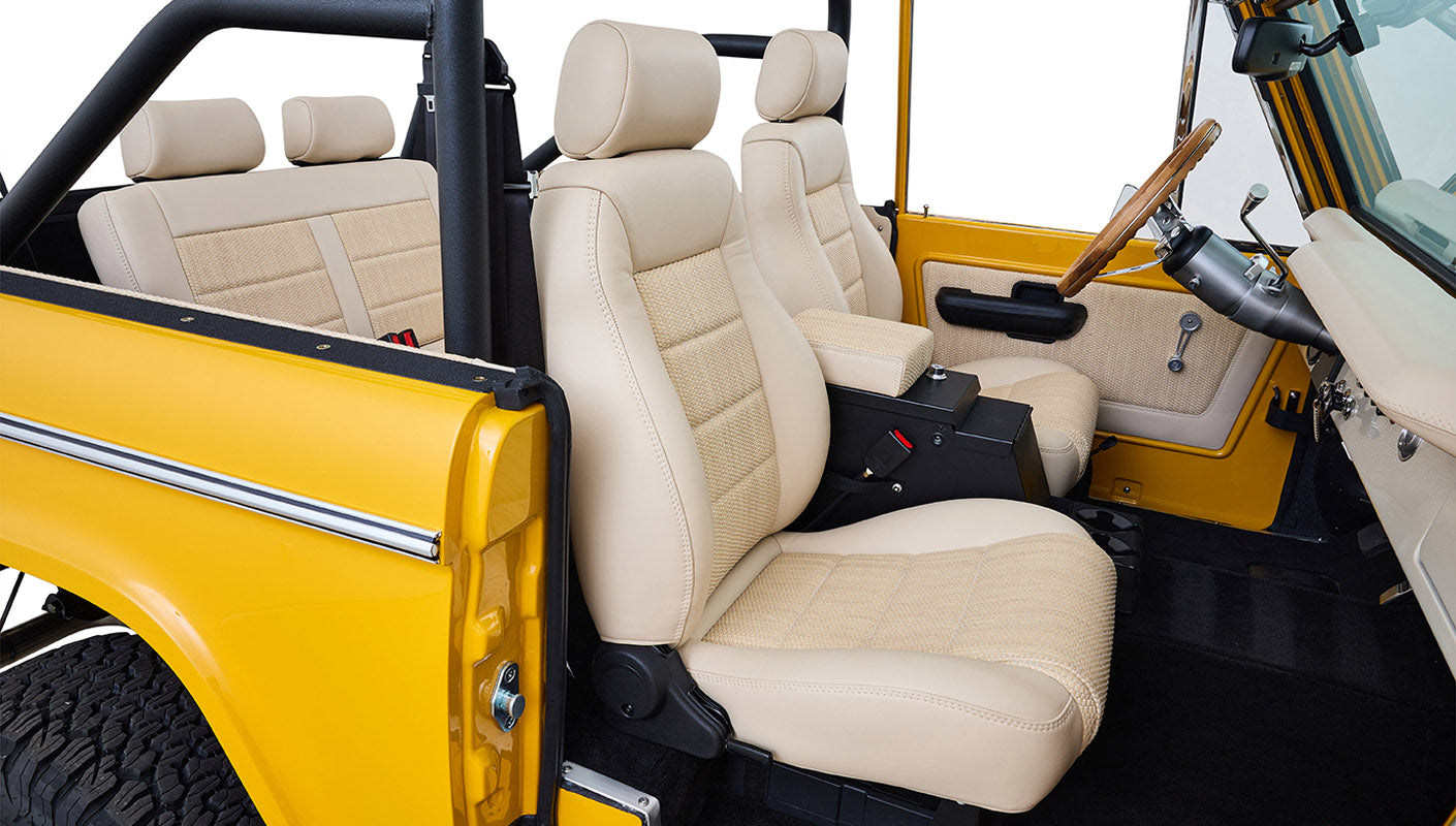 Ford Bronco 1975 in Chrome Yellow with custom Basket Weave Interior and Wimbledon White Wheels