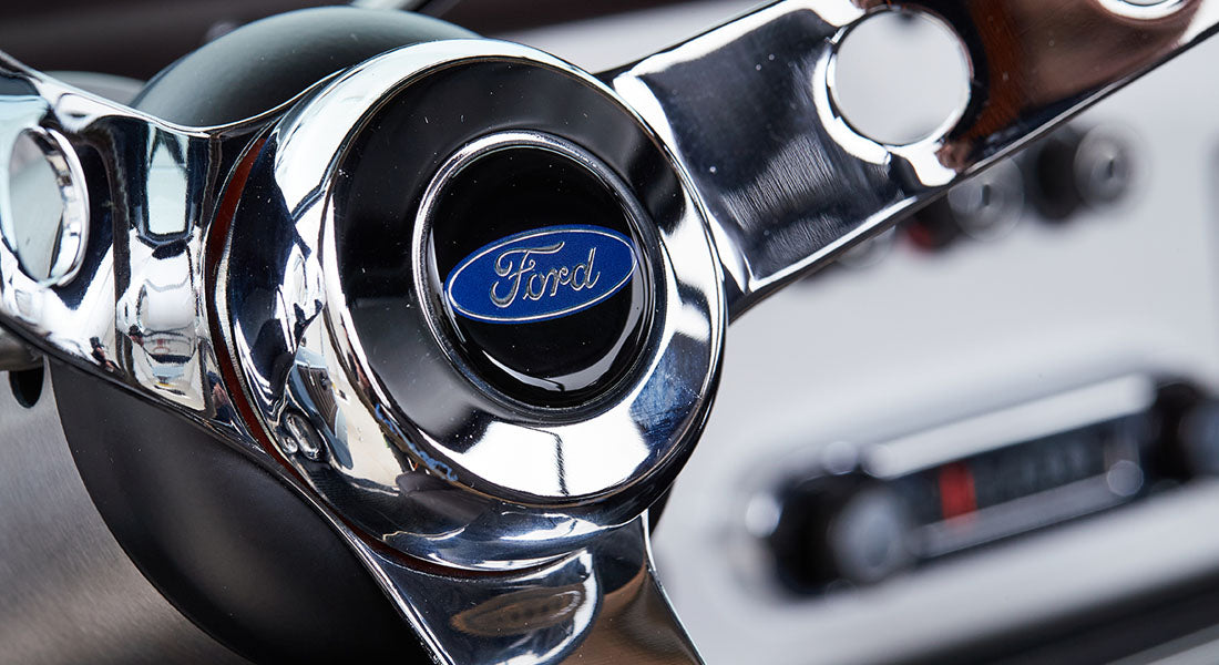 Shiny chrome Classic Ford Bronco steering wheel center with blue Ford logo