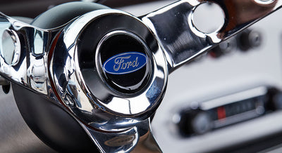 Shiny chrome Classic Ford Bronco steering wheel center with blue Ford logo