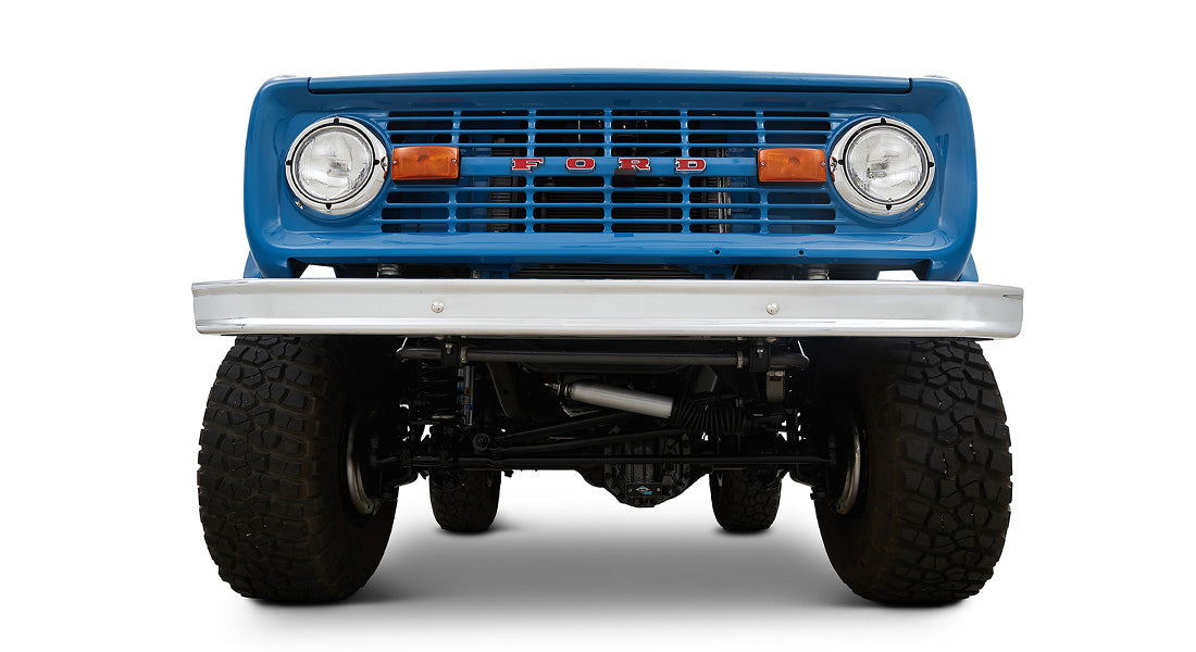 1976 Blue Classic Ford Bronco Coyote Series with black soft top and whiskey leather interior