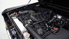 Detailed view of Classic Ford Bronco engine compartment with modern components and polished radiator