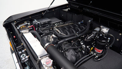 Detailed view of Classic Ford Bronco engine compartment with modern components and polished radiator