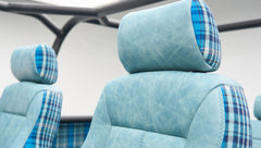 Close-up of blue plaid and textured upholstery headrests inside Classic Ford Bronco