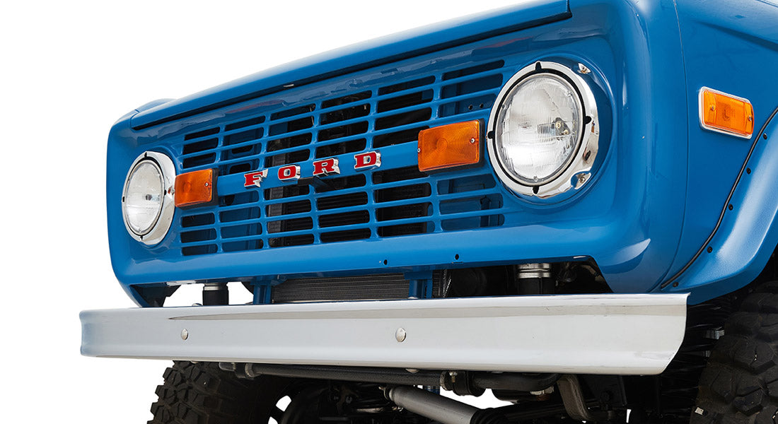 1976 Blue Classic Ford Bronco Coyote Series with black soft top and whiskey leather interior