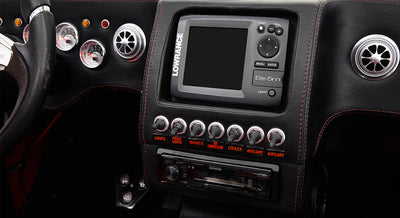Dashboard of Classic Ford Bronco featuring switches, digital device, and Kenwood stereo unit.