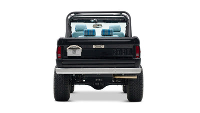 Rear view of Classic Ford Bronco in black with chrome bumper and visible suspension components