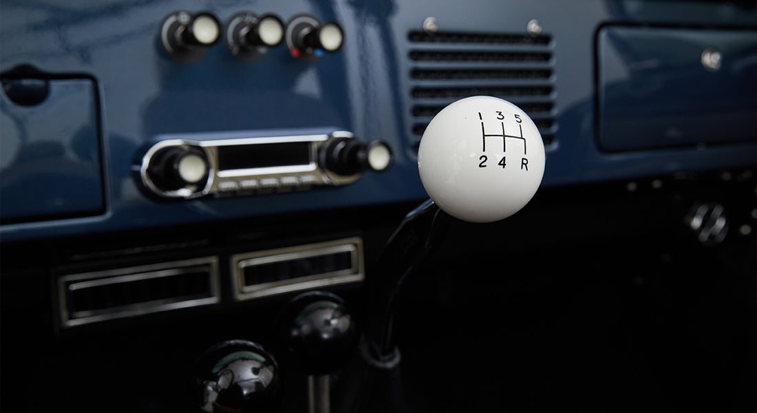 Classic Ford Bronco interior showing white spherical gear shift knob with 5-speed pattern