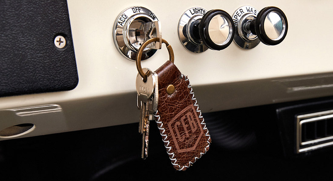 Classic Ford Bronco dashboard ignition switch with keys on CFB leather keychain.