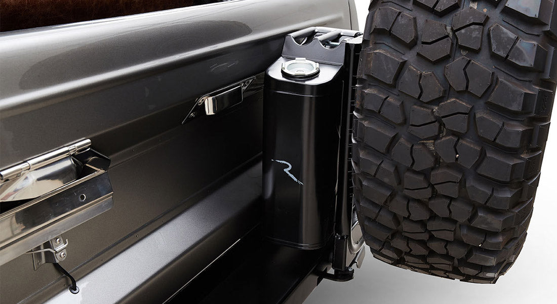 Black jerrycan mounted on rear side near spare tire of Classic Ford Bronco
