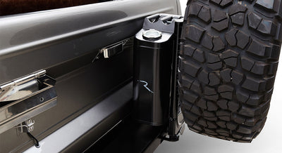 Black jerrycan mounted on rear side near spare tire of Classic Ford Bronco