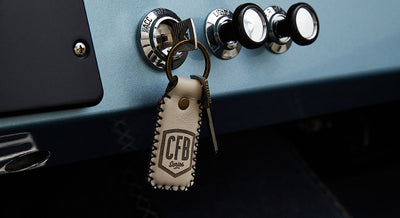Leather keychain with CFB Series logo hanging from ignition switch on a Classic Ford Bronco dashboard