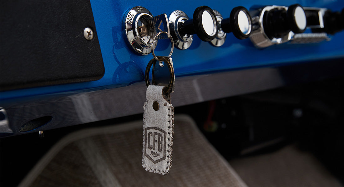 Key inserted in ignition with leather keychain embossed with CFB Series logo in Classic Ford Bronco