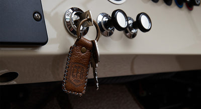 Leather keychain with CFB logo hanging from ignition switch and dashboard controls