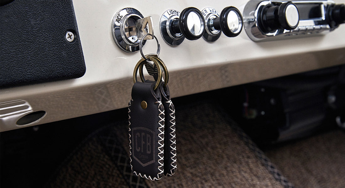 Ignition switch with keys attached to leather keychains hanging from Classic Ford Bronco dashboard