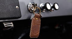 Leather keychain with embossed logo attached to ignition key in Classic Ford Bronco