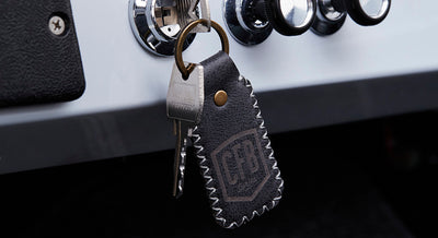 Set of keys in ignition with a stitched leather keychain bearing CFB logo