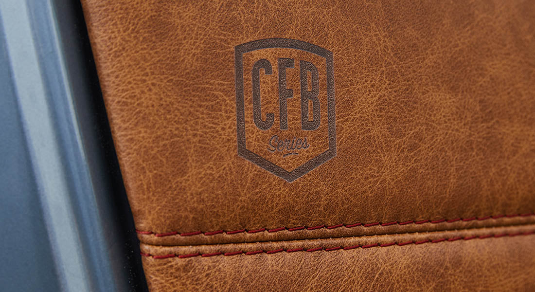 Brown leather surface with stamped CFB logo and red stitching detail