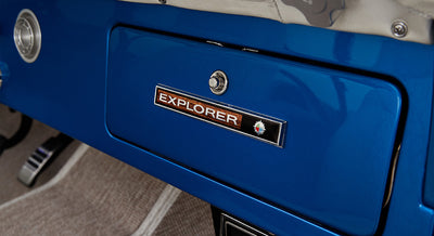 Blue glove compartment door with Explorer badge inside a Classic Ford Bronco