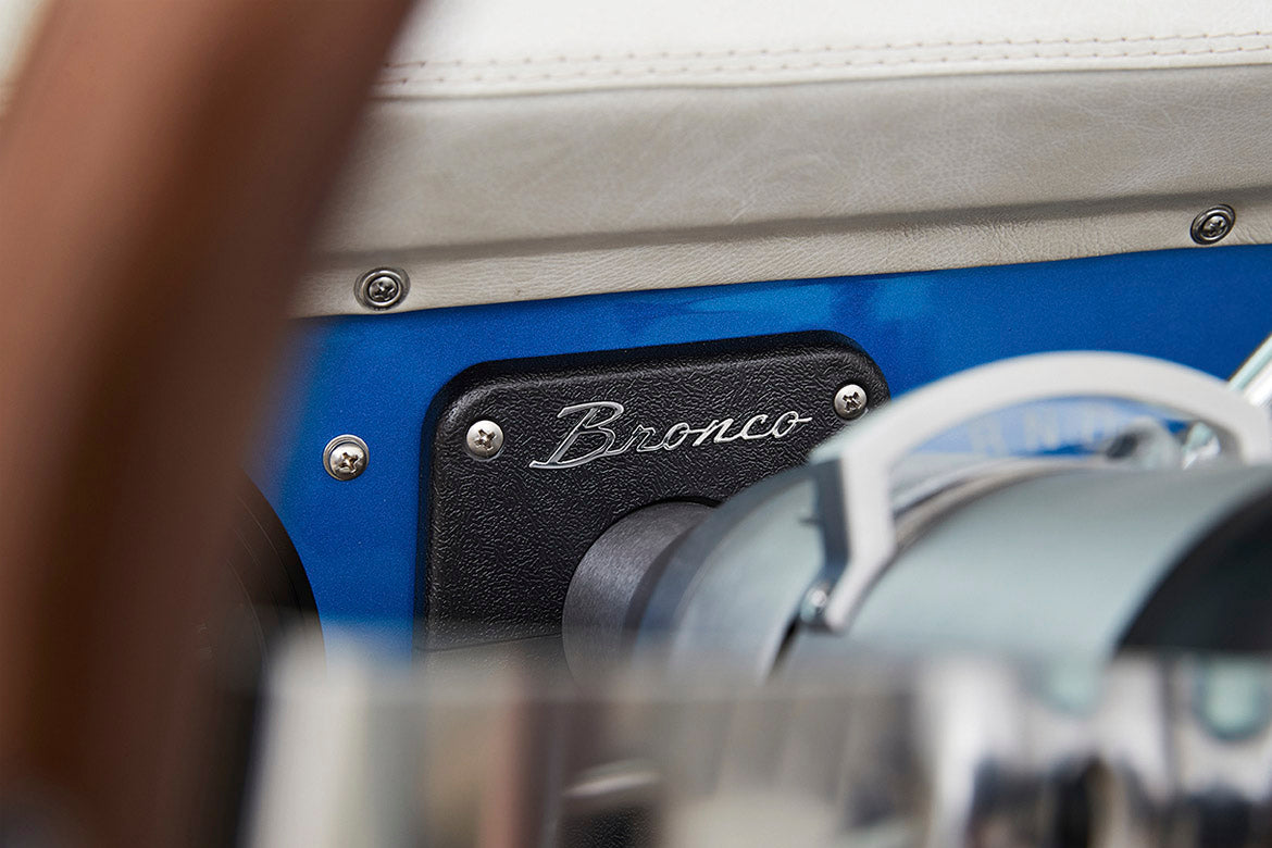 Close-up of Classic Ford Bronco dashboard with 'Bronco' script on black panel