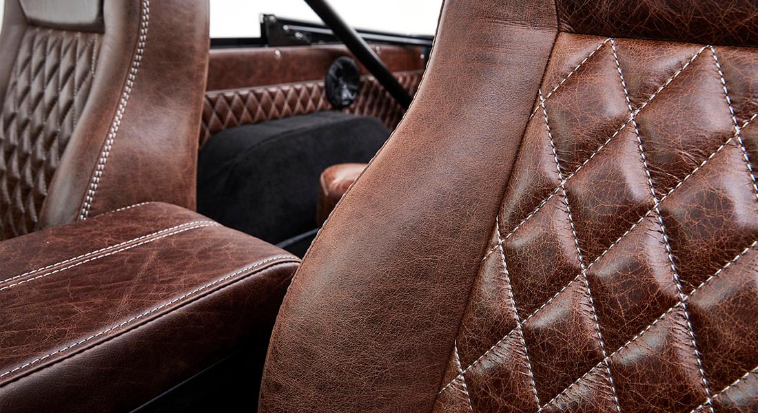 Close-up of brown diamond-stitched leather seats inside Classic Ford Bronco