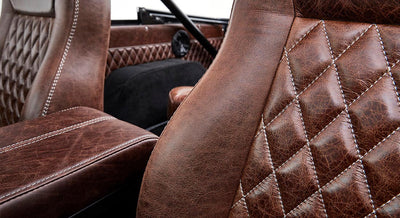 Close-up of brown diamond-stitched leather seats inside Classic Ford Bronco