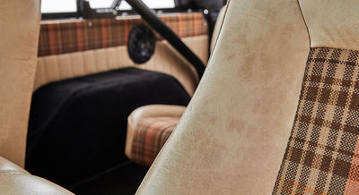 Plaid and beige seats and matching interior upholstery with a black roll cage
