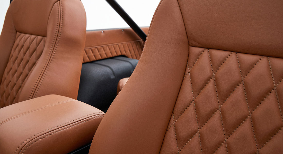 Close-up of tan leather seats with diamond stitching inside Classic Ford Bronco